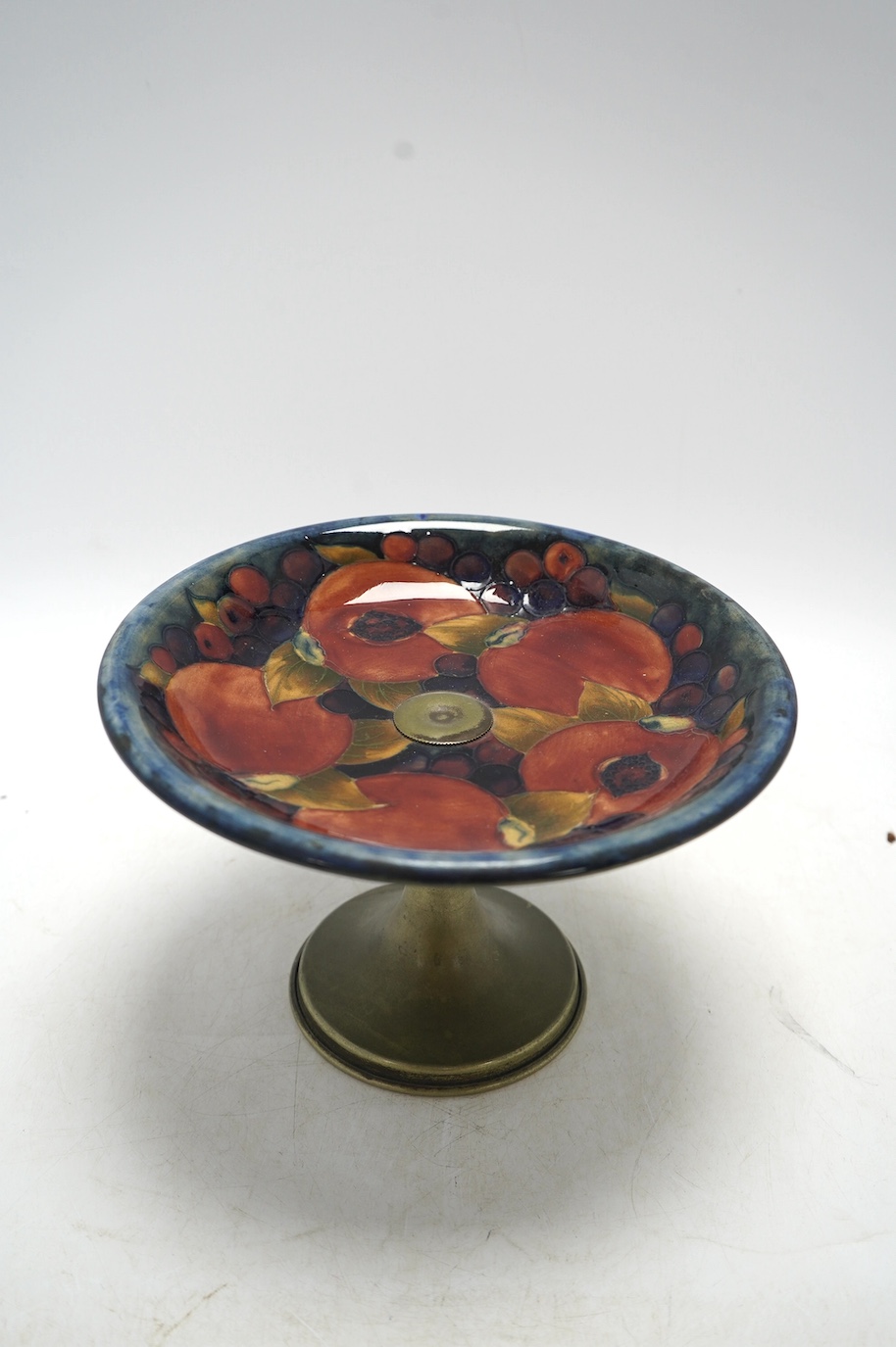 A Moorcroft Pomegranate comport, on plated metal pedestal, 14.5cm. Condition - fair, some wear to plating